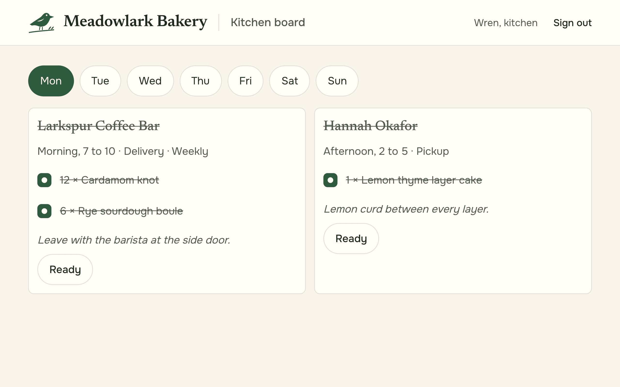The kitchen board for Monday: the coffee bar's weekly delivery and a layer cake for pickup, each a card with its time slot and a note for the kitchen, every item ticked off and both marked ready.